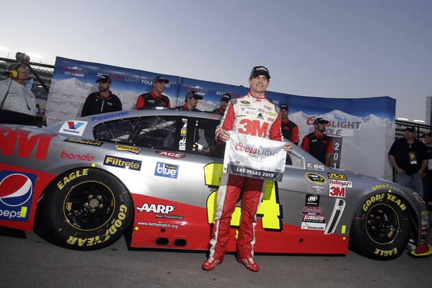 Jeff Gordon poses for photos after winning the pole position during qualifying for Sunday's NASCAR Sprint Cup Series auto race, Friday, March 6, 2015, in Las Vegas. (AP Photo/Isaac Brekken)