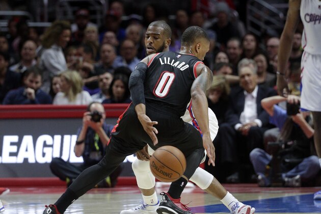 Portland Trail Blazers' Damian Lillard, front, tries to get the ball past Los Angeles Clippers' Chris Paul during the first half of an NBA basketball game Wednesday, March 4, 2015, in Los Angeles. (AP Photo/Jae C. Hong)