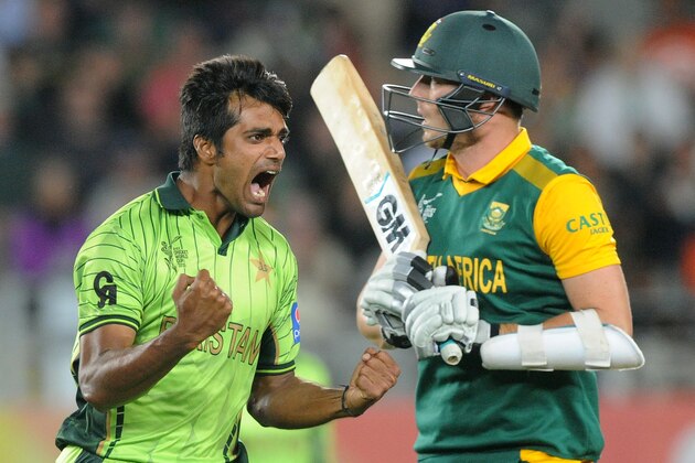 Pakistan bowler Rahat Ali, left, celebrates after taking the wicket of South Africa's Kyle Abbott, right, during their Cricket World Cup Pool B match in Auckland, New Zealand, Saturday, March 7, 2015. (AP Photo/Ross Setford)