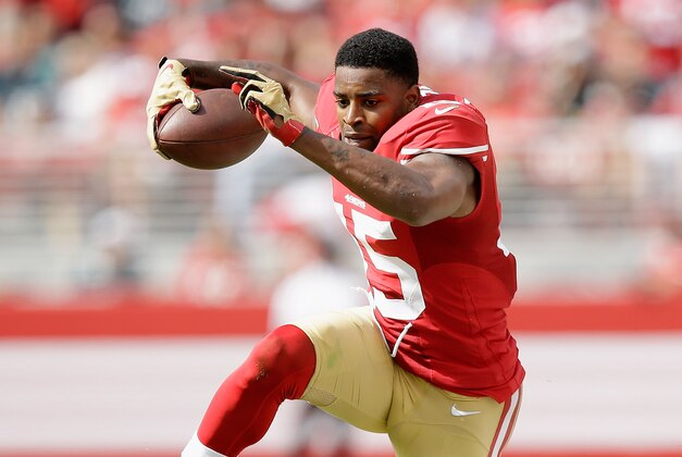 SANTA CLARA, CA - SEPTEMBER 28:  Michael Crabtree #15 of the San Francisco 49ers runs with the ball after he lost his helmet during the second quarter of their game against the Philadelphia Eagles at Levi's Stadium on September 28, 2014 in Santa Clara, California.  (Photo by Ezra Shaw/Getty Images)
