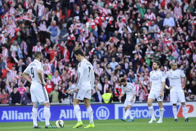 Real Madrid's Karim Benzema of France, left, and Cristiano Ronaldo of Portugal, center, stand by the ball after Athletic Bilbao scored a goal, during their La Liga soccer match, at San Mames stadium in Bilbao, northern Spain, Saturday, March 7, 2015. (AP Photo/Alvaro Barrientos)