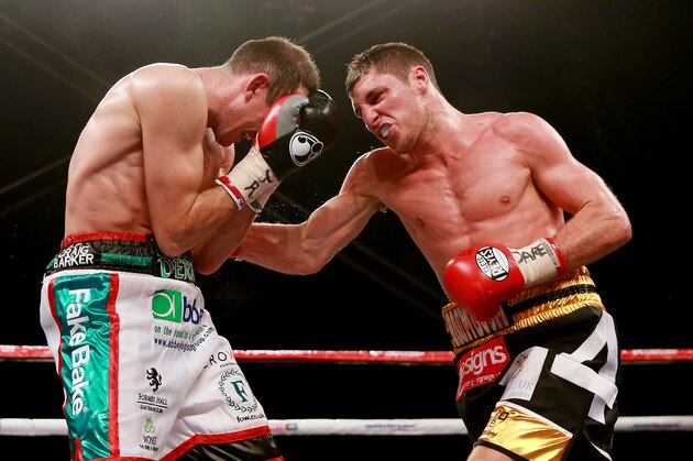 HULL, ENGLAND - JULY 13:  Derry Matthews (L) in action with Tommy Coyle during their Vacant Commonwealth Lightweight Championship bout at Craven Park Stadium on July 13, 2013 in Hull, England.  (Photo by Scott Heavey/Getty Images)