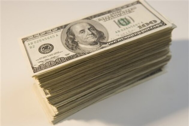 Tall stack of U.S. hundred dollar bills (Photo by: Tetra Images/AP Images)