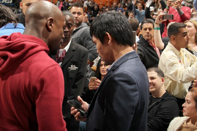 MIAMI, FL - JANUARY 27:  Boxers, Manny Pacquiao and Floyd Mayweather Jr talk before the game between the Milwaukee Bucks and Miami Heat on January 27, 2015 at American Airlines Arena in Miami, Florida. NOTE TO USER: User expressly acknowledges and agrees that, by downloading and or using this Photograph, user is consenting to the terms and conditions of the Getty Images License Agreement. Mandatory Copyright Notice: Copyright 2015 NBAE (Photo by Issac Baldizon/NBAE via Getty Images)