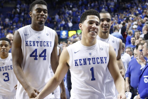 Dec 13, 2014; Lexington, KY, USA; Kentucky Wildcats guard Devin Booker (1) center Dakari Johnson (44) and forward Trey Lyles (41) celebrate after the game against the North Carolina Tar Heels at Rupp Arena. The Kentucky Wildcats defeated North Carolina Tar Heels 84-70. Mandatory Credit: Mark Zerof-USA TODAY Sports