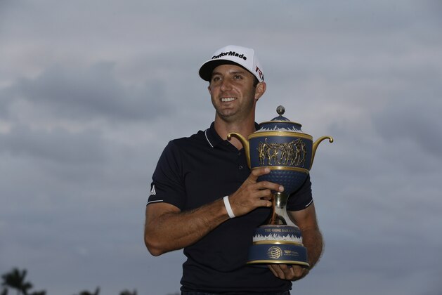 Dustin Johnson holds the Gene Sarazen Cup after wining the Cadillac Championship golf tournament, Sunday, March 8, 2015, in Doral, Fla. (AP Photo/Wilfredo Lee)