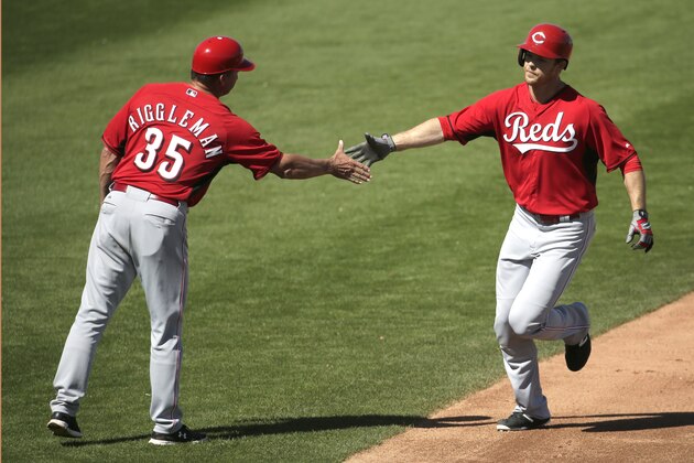 Cincinnati Reds' Brennan Boesch, right, celebrates with third base coach Jim Riggleman (35) after hitting a solo home run during the fifth inning of a spring training baseball game against the Kansas City Royals Saturday, March 7, 2015, in Surprise, Ariz. (AP Photo/Charlie Riedel)