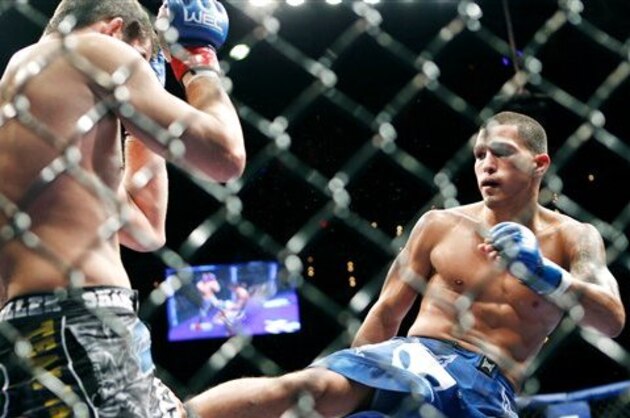 Shane Roller, left, and Anthony Pettis battle during their WEC lightweight mixed martial art match Wednesday, Aug. 18, 2010, in Las Vegas. Pettis defeated Roller with a third round submission. (AP Photo/Eric Jamison)