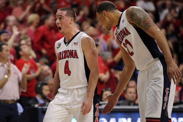 Mar 7, 2015; Tucson, AZ, USA; Arizona Wildcats guard T.J. McConnell (4) and forward Brandon Ashley (21) celebrate during the second half against the Stanford Cardinal at McKale Center. Arizona won 91-69 to win the regular season Pac-12 championship. Mandatory Credit: Casey Sapio-USA TODAY Sports