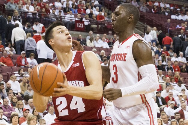 Mar 8, 2015; Columbus, OH, USA; Wisconsin Badgers guard Bronson Koenig (24) looks for a shot under pressure from Ohio State Buckeyes guard Shannon Scott (3) at Value City Arena. Wisconsin won the game 72-48. Mandatory Credit: Greg Bartram-USA TODAY Sports