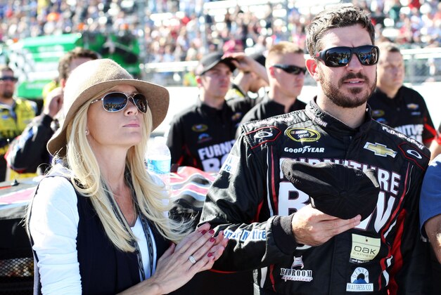 Oct 26, 2014; Martinsville, VA, USA; Sprint Cup Series driver Martin Truex Jr. (78) with his girlfriend Sherry Pollex during the national anthem before the Goody's Headache Relief Shot 500 at Martinsville Speedway. Mandatory Credit: Peter Casey-USA TODAY Sports