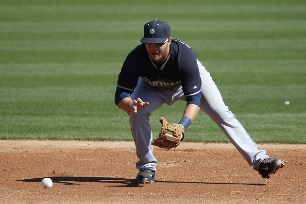 Seattle Mariners' D.J. Peterson fields a grounder before throwing out the runner at first base in the third inning of a spring training exhibition baseball game against the Los Angeles Dodgers Friday, March 6, 2015, in Phoenix. (AP Photo/John Locher)
