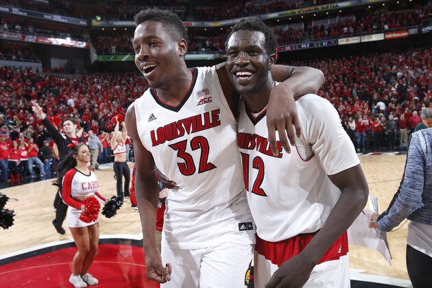 LOUISVILLE, KY - MARCH 7: Mangok Mathiang #12 of the Louisville Cardinals celebrates his winning basket with teammate Chinanu Onuaku #32 after the game against the Virginia Cavaliers at KFC Yum! Center on March 7, 2015 in Louisville, Kentucky. Louisville defeated Virginia 59-57. (Photo by Joe Robbins/Getty Images)