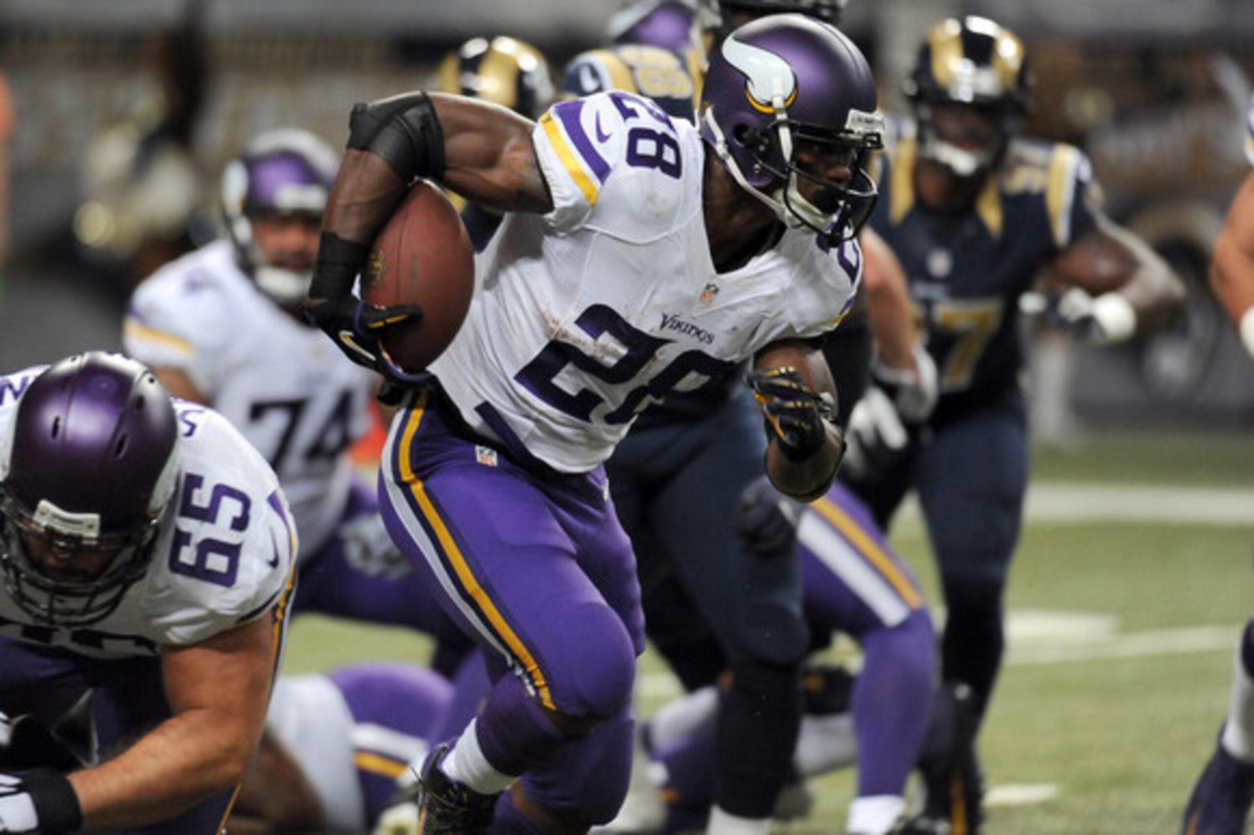 Minnesota Vikings running back Adrian Peterson runs with the ball during the first quarter an NFL football game against the St. Louis Rams Sunday, Sept. 7, 2014, in St. Louis. (AP Photo/L.G. Patterson)
