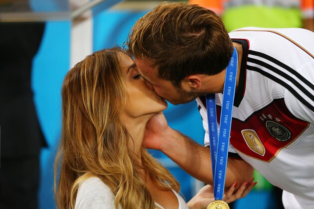 RIO DE JANEIRO, BRAZIL - JULY 13:  Mario Goetze of Germany kisses girlfriend Ann-Kathrin Brommel after defeating Argentina 1-0 in extra time during the 2014 FIFA World Cup Brazil Final match between Germany and Argentina at Maracana on July 13, 2014 in Rio de Janeiro, Brazil.  (Photo by Martin Rose/Getty Images)