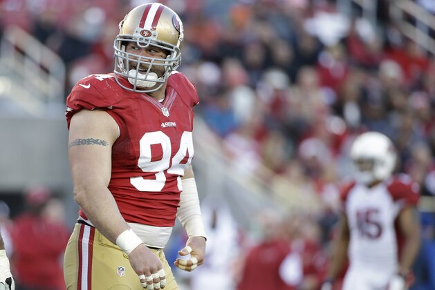 San Francisco 49ers defensive tackle Justin Smith (94) smiles during the second half of an NFL football game against the Arizona Cardinals in Santa Clara, Calif., Sunday, Dec. 28, 2014. (AP Photo/Marcio Jose Sanchez)