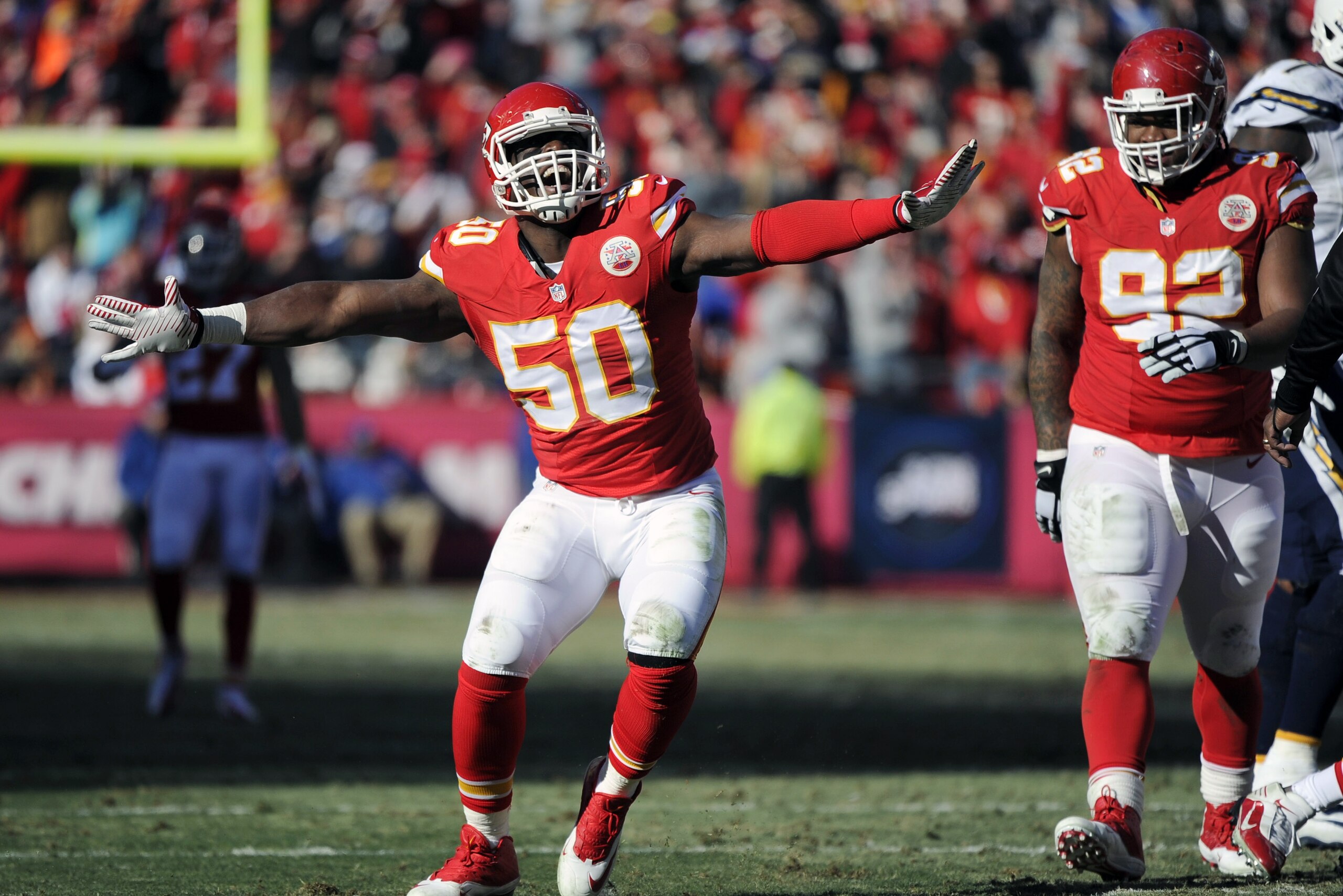 Kansas City Chiefs outside linebacker Justin Houston (50) celebrates a sacking of San Diego Chargers quarterback Philip Rivers with Chiefs nose tackle Dontari Poe (92) looking on during the first half of an NFL football game in Kansas City, Mo., Sunday, Dec. 28, 2014. (AP Photo/Ed Zurga)