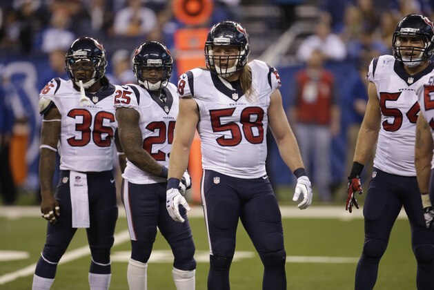 Houston Texans players, left, to right, D.J. Swearinger, Kareem Jackson, and Brooks Reed huddle during the second half of an NFL football game against the Indianapolis Colts in Indianapolis, Sunday, Dec. 14, 2014. (AP Photo/AJ Mast)