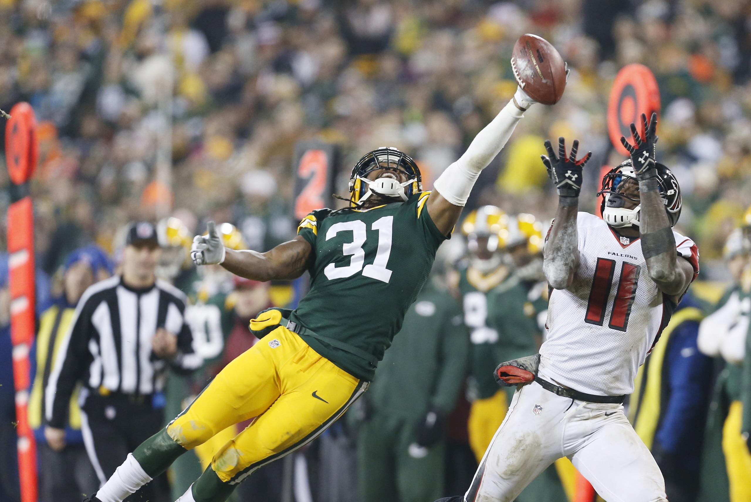 Green Bay Packers' Davon House breaks up a pass intended for Atlanta Falcons' Julio Jones during the second half of an NFL football game Monday, Dec. 8, 2014, in Green Bay, Wis. (AP Photo/Mike Roemer)