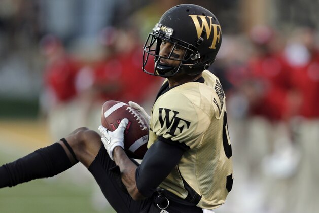 Wake Forest's Kevin Johnson intercepts a North Carolina State pass in the second half of an NCAA college football game in Winston-Salem, N.C., Saturday, Oct. 5, 2013. Wake Forest won 28-13. (AP Photo/Chuck Burton)