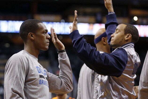 Dallas Mavericks' Rajon Rondo, left, gets a high-five from teammate Monta Ellis prior to an NBA basketball game against the Phoenix Suns Tuesday, Dec. 23, 2014, in Phoenix.  The Suns defeated the Mavericks 124-115. (AP Photo/Ross D. Franklin)