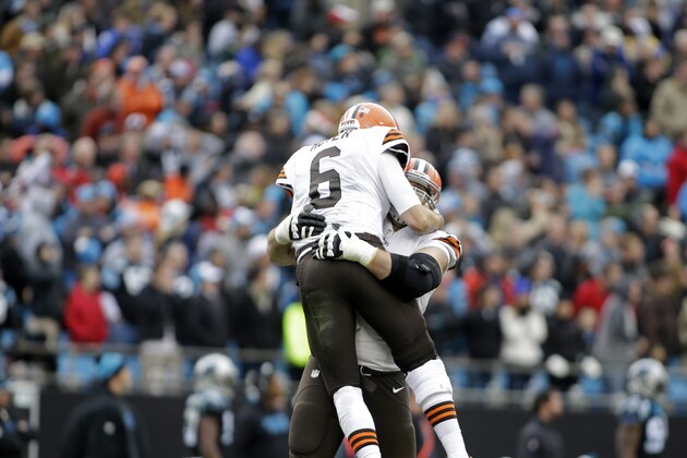 Cleveland Browns' Brian Hoyer (6) jumps into the arms of a teammate after throwing a touchdown pass against the Carolina Panthers in the second half of an NFL football game in Charlotte, N.C., Sunday, Dec. 21, 2014. The Panthers won 17-13. (AP Photo/Bob Leverone)