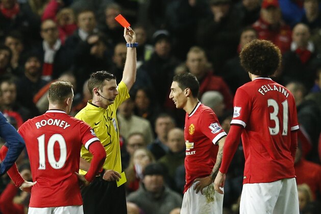 Referee Michael Oliver shows a red card to Manchester United’s Angel Di Maria, second right, during the English FA Cup quarterfinal soccer match between Manchester United and Arsenal at Old Trafford Stadium, Manchester, England, Monday, March 9, 2015. (AP Photo/Jon Super)