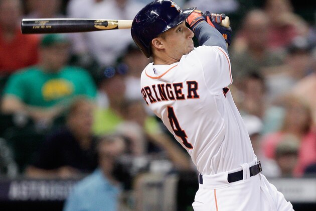 HOUSTON, TX - JULY 01:  George Springer #4 of the Houston Astros flies out to center against the Seattle Mariners at Minute Maid Park on July 1, 2014 in Houston, Texas.  (Photo by Bob Levey/Getty Images)