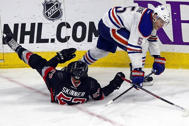 Edmonton Oilers' Mark Fayne (5) collides with Carolina Hurricanes' Jeff Skinner (53) during the third period of an NHL hockey game in Raleigh, N.C., Sunday, March 8, 2015, in Raleigh, N.C. The Hurricanes won 7-4. (AP Photo/Karl B DeBlaker)