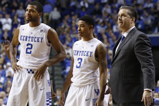 From left, Kentucky's Aaron Harrison, Tyler Ulis, and head coach John Calipari pause for a moment during the second half of an NCAA college basketball game, Saturday, Dec. 13, 2014. Kentucky won 84-70. (AP Photo/James Crisp)