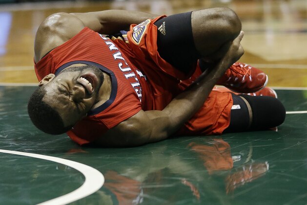 New Orleans Pelicans' Tyreke Evans holds his ankle during an NBA basketball game against the Milwaukee Bucks, Monday, March 9, 2015, in Milwaukee. The Pelicans won 114-103. (AP Photo/Morry Gash)