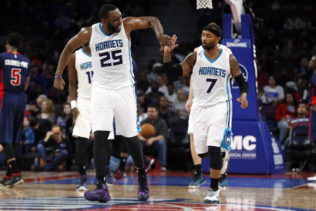 Charlotte Hornets center Al Jefferson (25) and Mo Williams (7) celebrate a basket against the Detroit Pistons in the second half of an NBA basketball game in Auburn Hills, Mich., Sunday, March 8, 2015. (AP Photo/Paul Sancya)