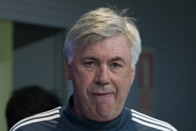 Real Madrid's coach Carlo Ancelotti enters the room to give for a press conference on Monday, March 9, 2015 in Madrid, Spain. Real Madrid will play Schalke 04 Tuesday in a round of 16 second leg Champions League soccer match. (AP Photo/Paul White)