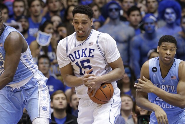 Duke's Jahlil Okafor (15) reaches for the ball against North Carolina's Joel James, left, and Isaiah Hicks during the first half of an NCAA college basketball game in Durham, N.C., Wednesday, Feb. 18, 2015. (AP Photo/Gerry Broome)