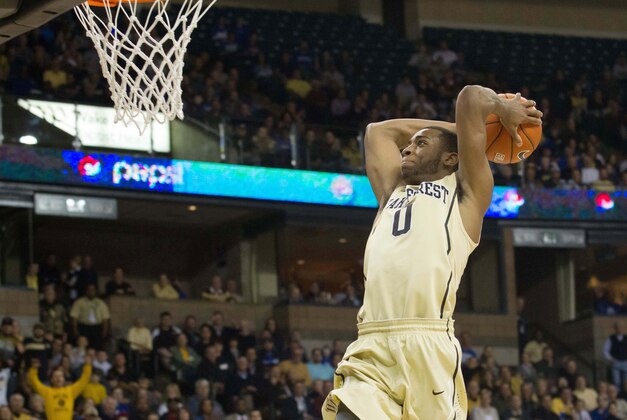 Mar 5, 2014; Winston-Salem, NC, USA; Wake Forest Demon Deacons guard Codi Miller-McIntyre (0) goes up for a dunk during the first half against the Duke Blue Devils at Lawrence Joel Veterans Memorial Coliseum. Mandatory Credit: Jeremy Brevard-USA TODAY Sports