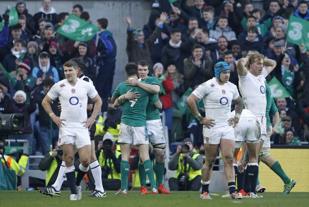 England players reacts as Irish players celebrate their 19-9 win in rugby union 6 nations match at the Aviva stadium, Dublin, Ireland, Sunday, March, 1, 2015.  (AP Photo/Peter Morrison)