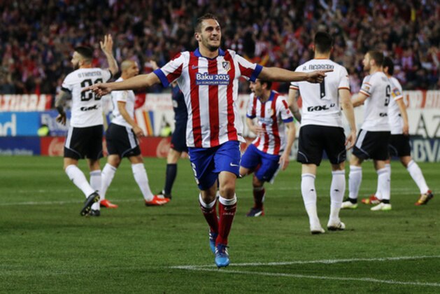 Atletico de Madrid’s Koke, center, celebrates after scoring a goal during a Spanish La Liga soccer match between Atletico de Madrid and Valencia at the Vicente Calderon stadium in Madrid, Spain, Sunday, March 8, 2015. (AP Photo/Daniel Ochoa de Olza)