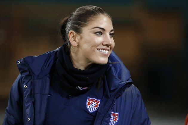 FILE - In this Oct. 20, 2014, file photo, U.S. goalkeeper Hope Solo stands on the sidelines before a CONCACAF soccer match against Haiti in Washington. Solo was reinstated by U.S. Soccer after a 30-day suspension and is on the travel roster for next month's Algarve Cup in Portugal.  (AP Photo/Alex Brandon, File)