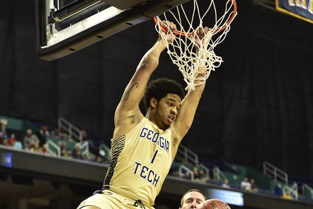 Mar 10, 2015; Greensboro, NC, USA; Georgia Tech Yellow Jackets guard Tadric Jackson (1) scores as Boston College Eagles center Dennis Clifford (24) defends in the first half first round of the ACC Tournament at Greensboro Coliseum. Mandatory Credit: Bob Donnan-USA TODAY Sports
