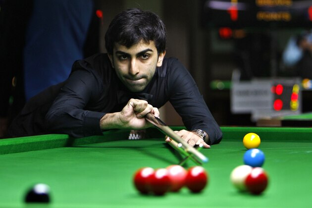 India's Pankaj Advani plays a shot during a round robin league match against Poland's Marcin Nitschke, unseen, at the International Billiards and Snooker Federation (IBSF) World Snooker Championship in Bangalore, India, Tuesday, Nov. 29, 2011. The six day event which started Monday have participants from 41 countries. (AP Photo/Aijaz Rahi)