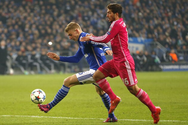 Schalke's Felix Platte, left, challenges for the ball with Real Madrid's Lucas Silva during the Champions League round of 16 first leg soccer match between FC Schalke 04 and Real Madrid on Wednesday, Feb. 18, 2015 in Gelsenkirchen, Germany. (AP Photo/Frank Augstein)