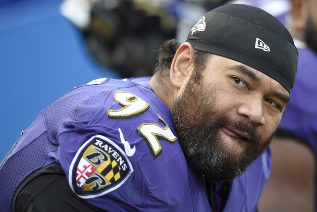 FILE - In this Nov. 9, 2014, file photo, Baltimore Ravens defensive end Haloti Ngata watches the action from the sidelines during the second half of an NFL football game against the Tennessee Titans in Baltimore. Ngata and the Ravens can only hope that a four-week suspension won't hinder his effectiveness in Saturday night's playoff game against the Pittsburgh Steelers.  (AP Photo/Nick Wass, File)