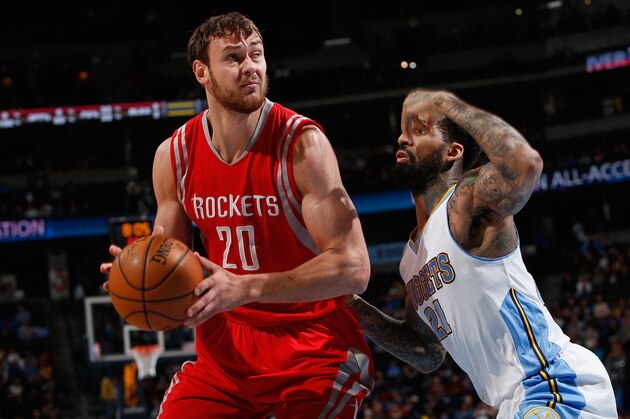 DENVER, CO - MARCH 07:  Donatas Motiejunas #20 of the Houston Rockets controls the ball against Wilson Chandler #21 of the Denver Nuggets at Pepsi Center on March 7, 2015 in Denver, Colorado. NOTE TO USER: User expressly acknowledges and agrees that, by downloading and or using this photograph, User is consenting to the terms and conditions of the Getty Images License Agreement.  (Photo by Doug Pensinger/Getty Images)