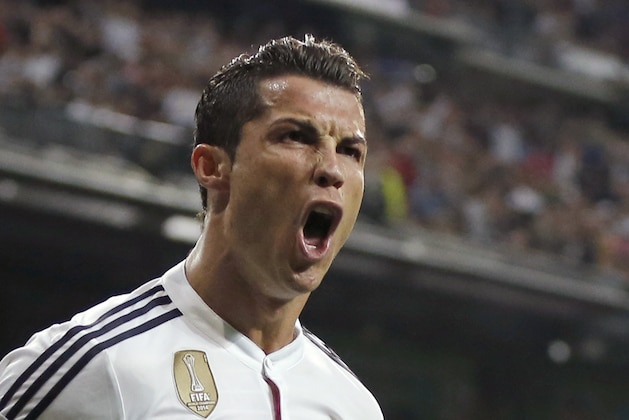 Real Madrid's Cristiano Ronaldo celebrates scoring 2-2 during a Champions League soccer match round of 16 second leg, between Real Madrid and Schalke 04 at Santiago Bernabeu stadium, in Madrid, Spain, Tuesday, March 10, 2015. (AP Photo/Daniel Ochoa de Olza)