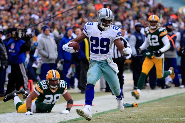 GREEN BAY, WI - JANUARY 11:   DeMarco Murray #29 of the Dallas Cowboys carries the football to the endzone for a touchdown against the Green Bay Packers in the third quarter of the 2015 NFC Divisional Playoff game at Lambeau Field on January 11, 2015 in Green Bay, Wisconsin.  (Photo by Rob Carr/Getty Images)
