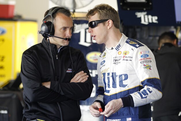 Brad Keselowski, right, talks with his crew chief Paul Wolfe in his garage during a practice session for the Daytona 500 NASCAR Sprint Cup Series auto race at Daytona International Speedway, Wednesday, Feb. 18, 2015, in Daytona Beach, Fla. (AP Photo/Terry Renna)
