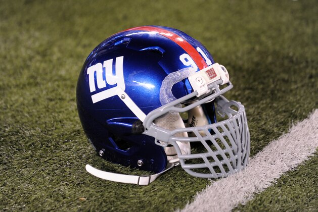 The helmet of New York Giants defensive end Justin Tuck sits on the field during the second half of an NFL football game against the Dallas Cowboys Wednesday, Sept. 5, 2012, in East Rutherford, N.J. The Cowboys won the game 24-17. (AP Photo/Bill Kostroun)