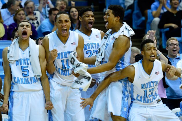 CHAPEL HILL, NC - DECEMBER 07:  (L-R) Marcus Paige #5, Brice Johnson #11, Isaiah Hicks #22, Kennedy Meeks #3 and J.P. Tokoto #13 of the North Carolina Tar Heels cheer on the reserves during the final minute of their game against the East Carolina Pirates at the Dean Smith Center on December 7, 2014 in Chapel Hill, North Carolina. North Carolina won 108-64.  (Photo by Grant Halverson/Getty Images)