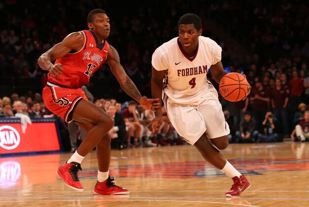 Dec 14, 2014; New York, NY, USA;  Fordham Rams guard Eric Paschall (4) drives past St. John's Red Storm forward Chris Obekpa (12) during the first half at Madison Square Garden. Mandatory Credit: Anthony Gruppuso-USA TODAY Sports