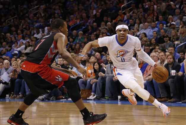 Oklahoma City Thunder guard Russell Westbrook (0) drives around Toronto Raptors guard Kyle Lowry (7) during an NBA basketball game between the Toronto Raptors and the Oklahoma City Thunder in Oklahoma City, Sunday, March 8, 2015. (AP Photo/Sue Ogrocki)
